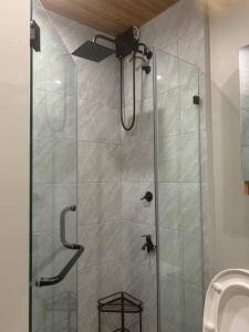 a shower stall in a bathroom with a toilet at Tranquil - Unit in Nuvali located at 5th floor w Balcony in Lagundi