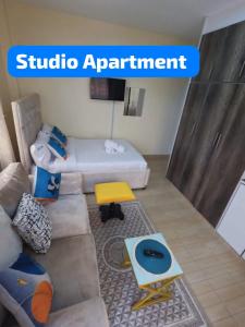 a living room with a couch and a table at Ravic Homes Studio in Nairobi