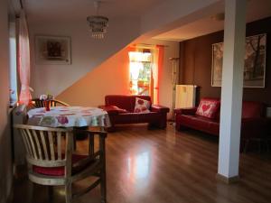 a living room with a table and a couch at Privat Vrbov 23 in Vrbov