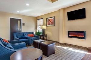 a living room with a couch and a fireplace at Comfort Inn Clinton in Clinton
