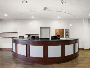 a large lobby with a bar with two chairs at Comfort Suites Lindale in Lindale +25 photos