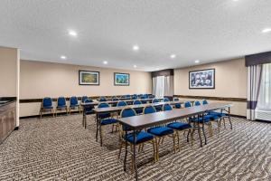 a conference room with tables and blue chairs at Comfort Inn Clinton in Clinton +29 photos