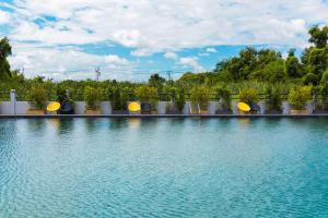 a large pool of water with trees in the background at SureStay By Best Western Iconic Suvarnabhumi in Samut Prakan