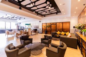 a lobby with couches and chairs in a building at SureStay By Best Western Iconic Suvarnabhumi in Samut Prakan +79 photos