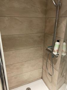 a shower in a bathroom with a glass door at Les nuitées du Rangen in Thann +14 photos
