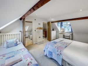 a bedroom with two beds and a bathroom at Redway Lodge in Porlock