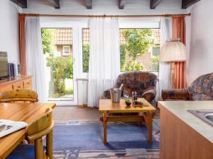 ein Wohnzimmer mit Tisch und Stühlen in der Unterkunft Holiday Home Koralle-1 by Interhome in Norddeich
