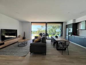 a living room with a couch and a table at Casa OS BALCÓNS in Boiro