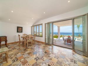 a dining room with a view of the ocean at Holiday Home Xoroi by Interhome in Colonia de Sant Pere