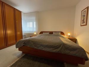 a bedroom with a bed and two night stands at Apartment Schwarzwaldblick-27 by Interhome in Obertal +16 photos