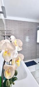 a bunch of white flowers on a counter in a bathroom at Villa Roferos 32 in Puerto del Carmen