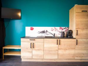a kitchen with a sink and a wooden cabinet at Kitsuné Lodge zen d'inspiration japonaise in Chaintré +10 photos