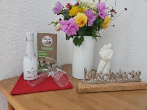 拉芬斯堡Farmhaus的一张桌子,上面有花瓶和一瓶