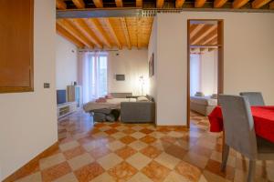 a living room with a bed and a table in a room at HISTORIC CENTER VIEW-2 minutes from Arena & Juliet's house- Mazzini Palace in Verona