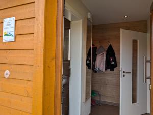 a room with a wooden wall and a closet at Ferienhaus Ostara in Hasselfelde