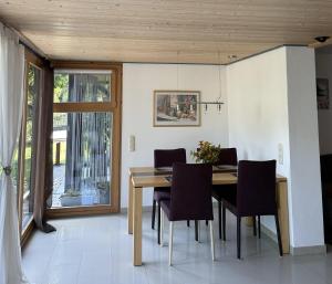 a dining room with a wooden table and chairs at Ferienwohnung Koch mit Terrasse in Riedenburg
