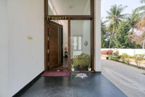 an open door to a living room with a couch at Sais lotus villa -Home stay and Event venue in Coimbatore