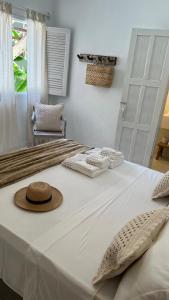 Ένα ή περισσότερα κρεβάτια σε δωμάτιο στο Casa Maria Trancoso Bahia