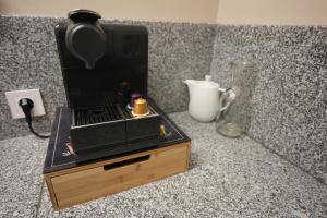 a coffee maker sitting on top of a wooden box at Pooltugal House in São Romão