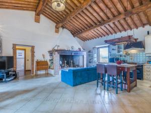 a living room with a blue couch and a fireplace at Holiday Home Podere Palazzetto by Interhome in Buonconvento