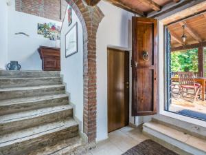 a door to the porch of a house with stairs at Holiday Home Podere Palazzetto by Interhome in Buonconvento
