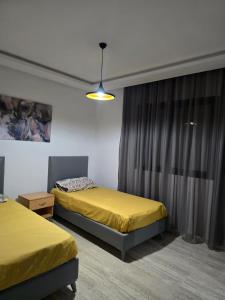 a room with two beds and a window at Luxury apartment in Ariana