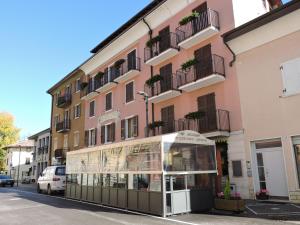 a building with a glass storefront in front of it at Hotel Zeni in Brentonico