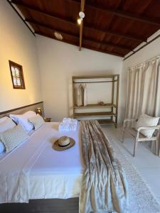Ένα ή περισσότερα κρεβάτια σε δωμάτιο στο Casa Maria Trancoso Bahia