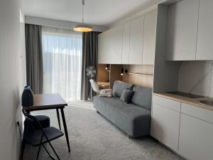 a living room with a couch and a table at Wilanów Residence Apartments in Warsaw