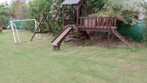 a wooden playground in a yard with at Liguria in San Geronimo