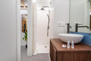 a bathroom with a white sink on a wooden counter at Tiendas 26 in Almería