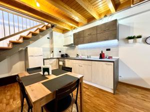a kitchen with a wooden table and a counter top at Little Loft in Timişoara +25 photos