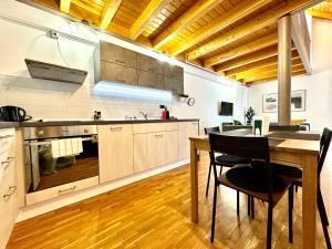 a kitchen with a table and a dining room at Little Loft in Timişoara