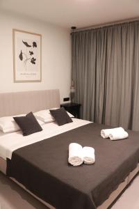 a bedroom with two beds with towels on them at PaMar Downtown Apartments in Split