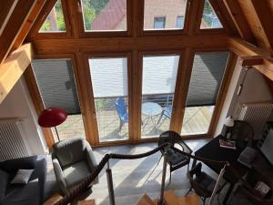 a room with windows and chairs in a house at Müritzblick OG in Marienfelde