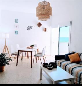 a living room with a couch and a table at Seaview Apartment, Playa Chica, Las Gaviotas, Apartamento 311 in Santa Cruz de Tenerife