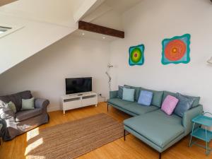 a living room with a couch and a tv at Ocean View in Alnwick