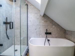 a bathroom with a tub and a glass shower at Ocean View in Alnwick +27 photos