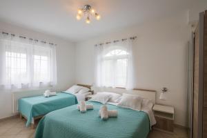 Postel nebo postele na pokoji v ubytování Villa Kristina