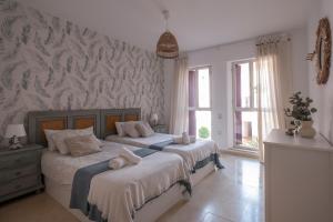 Łóżko lub łóżka w pokoju w obiekcie Aquamarine apartment in Marina Sotogrande