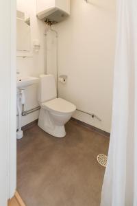 a bathroom with a toilet and a sink at Apelvikstrand Lägenheter in Varberg