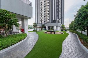 a walkway with a green lawn in front of a building at Cheras Kuala Lumpur luxury condo in Cheras