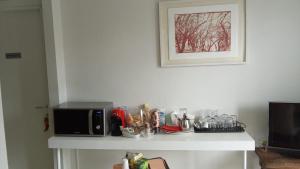 a white counter with a microwave and a coffee maker at Home & B in Arezzo