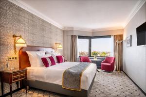 a hotel room with a bed and a large window at Hotel Barsey by Warwick in Brussels