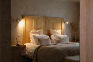 a bedroom with a large bed with white pillows at Fiddle + Bow Hotel in Doolin