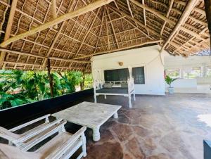 a pavilion with a table and chairs in a room at WHITE Nyumba Malindi - Boutique Villa in Malindi