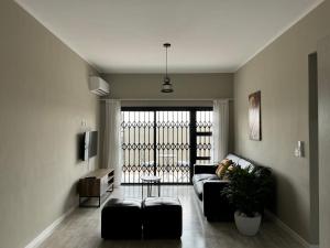 a living room with a couch and a table at SiaMo Suite in Gaborone