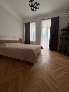 a bedroom with a bed and a wooden floor at Ortevani Guest House in Kvareli +31 photos