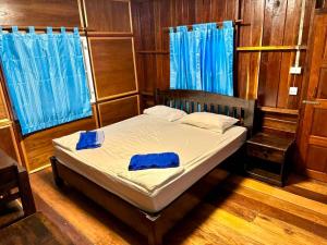 a bedroom with a bed with blue towels on it at Bigblue haadyuan in Haad Yuan