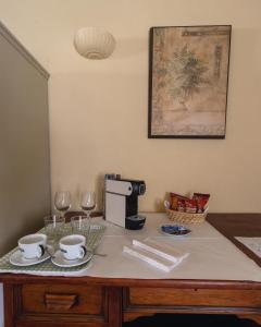 a table with two cups and a coffee maker at Hostal La Riera de Peratallada in Peratallada +15 photos